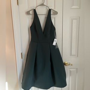 Brand new Sleeveless green knee length dress with deep V neckline